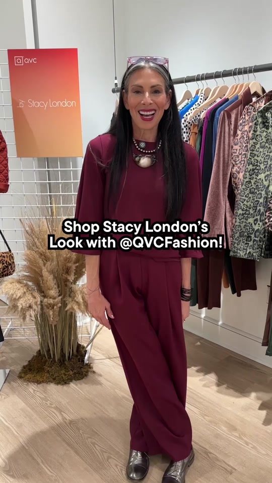 A smiling presenter wearing a burgundy outfit in a QVC Fashion video